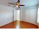 Bedroom with wood floors, ceiling fan, closet and bathroom at 399 Bal Harbor Blvd, Punta Gorda, FL 33950
