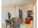 Cozy dining area adjacent to the kitchen, featuring a round table with stylish chairs and modern pendant lighting at 399 Bal Harbor Blvd, Punta Gorda, FL 33950