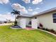 Manicured lawn with white privacy fence, brick patio, and well-maintained landscaping at 399 Bal Harbor Blvd, Punta Gorda, FL 33950