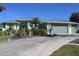 Charming, single-story home boasts a lush front yard, swaying palms, and a convenient two-car garage at 399 Bal Harbor Blvd, Punta Gorda, FL 33950