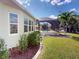 Well maintained yard with shrubbery and view of screened-in pool at 399 Bal Harbor Blvd, Punta Gorda, FL 33950