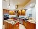 Gourmet kitchen with stainless steel appliances, granite countertops, custom cabinets, and an island at 399 Bal Harbor Blvd, Punta Gorda, FL 33950