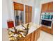 Bright kitchen with granite island, stainless steel fridge, and custom wood cabinets at 399 Bal Harbor Blvd, Punta Gorda, FL 33950