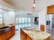 Open kitchen with granite island, modern appliances, and view to a bright living room at 399 Bal Harbor Blvd, Punta Gorda, FL 33950