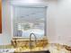 Kitchen sink area offers a pool view from the window over granite countertops at 399 Bal Harbor Blvd, Punta Gorda, FL 33950