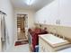 Laundry room features a utility sink, cabinets, and modern washer and dryer at 399 Bal Harbor Blvd, Punta Gorda, FL 33950