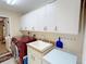 Laundry room features a utility sink, cabinets, and modern washer and dryer at 399 Bal Harbor Blvd, Punta Gorda, FL 33950