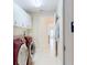 Laundry room features a utility sink, cabinets, and modern washer and dryer at 399 Bal Harbor Blvd, Punta Gorda, FL 33950