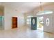 Bright living room boasts neutral tile floors, a ceiling fan, and an open entryway for modern living at 399 Bal Harbor Blvd, Punta Gorda, FL 33950