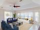 Bright living room with comfortable seating, a ceiling fan, and views of the pool and backyard at 399 Bal Harbor Blvd, Punta Gorda, FL 33950