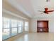 Bright living room featuring tile floors, windows, and a wooden built-in entertainment center at 399 Bal Harbor Blvd, Punta Gorda, FL 33950