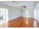 Spacious living room features gleaming hardwood floors and access to the screened patio at 399 Bal Harbor Blvd, Punta Gorda, FL 33950