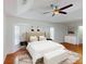 Spacious primary bedroom with hardwood floors, tray ceilings, and an upholstered headboard with bay windows at 399 Bal Harbor Blvd, Punta Gorda, FL 33950