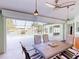 Covered patio featuring dining set, ceiling fan, and a view of the water and pool at 399 Bal Harbor Blvd, Punta Gorda, FL 33950