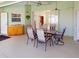 Covered outdoor patio features a dining set, outdoor sink, and view into the house at 399 Bal Harbor Blvd, Punta Gorda, FL 33950