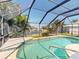 Relaxing screened-in pool with beautiful water view and tropical landscaping at 399 Bal Harbor Blvd, Punta Gorda, FL 33950