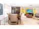 An open dining room leads into the living room, showcasing a large cabinet and ample seating at 4051 Rock Creek Dr, Port Charlotte, FL 33948
