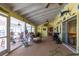 Large sunroom with ceiling fans, casual seating, and tiled flooring at 4051 Rock Creek Dr, Port Charlotte, FL 33948