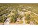 An aerial view showing the property's layout and location nestled within a quiet, forested neighborhood at 4631 Baynes Rd, North Port, FL 34288