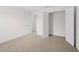 Bright bedroom with neutral carpet and doors leading to additional rooms and closet at 4631 Baynes Rd, North Port, FL 34288