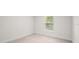 A cozy bedroom features plush carpeting and a window with natural light at 4631 Baynes Rd, North Port, FL 34288