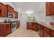 Kitchen boasting stainless steel appliances, wood cabinets, granite countertops, and ample space at 4631 Baynes Rd, North Port, FL 34288