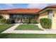 Beautiful home entrance showcasing lush landscaping and a cozy screened-in porch at 611 Bal Harbor Blvd, Punta Gorda, FL 33950