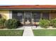 Inviting front porch featuring a cozy seating area and views of the landscaped yard at 611 Bal Harbor Blvd, Punta Gorda, FL 33950