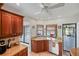 Bright kitchen boasts tile flooring, granite counters, stainless dishwasher, and a view of the pool at 611 Bal Harbor Blvd, Punta Gorda, FL 33950