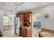 Efficient kitchen features dark wood cabinets, granite counters and stainless fridge with seamless flow into the dining and living rooms at 611 Bal Harbor Blvd, Punta Gorda, FL 33950
