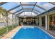 Relaxing screened-in pool area with comfortable seating and view of the canal at 611 Bal Harbor Blvd, Punta Gorda, FL 33950
