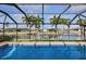 Screened in pool with blue water and view of canal at 611 Bal Harbor Blvd, Punta Gorda, FL 33950