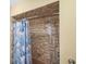 Tiled shower with a shower head and a blue shower curtain featuring sea life at 611 Bal Harbor Blvd, Punta Gorda, FL 33950