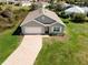 An aerial view of a well-maintained property featuring a long brick driveway and a charming single-story home at 616 Posadas Cir, Punta Gorda, FL 33983