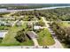 Aerial view of homes in a leafy neighborhood near a waterfront area, highlighting the community setting at 616 Posadas Cir, Punta Gorda, FL 33983