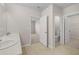 Bright bathroom with double vanity, tile flooring, and access to the toilet and closet at 616 Posadas Cir, Punta Gorda, FL 33983