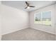 Carpeted bedroom with a window and ceiling fan at 616 Posadas Cir, Punta Gorda, FL 33983