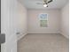 A clean, carpeted bedroom with a ceiling fan, window with blinds, and a neutral color palette at 616 Posadas Cir, Punta Gorda, FL 33983