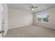Carpeted bedroom with ceiling fan and window providing natural light at 616 Posadas Cir, Punta Gorda, FL 33983