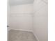 Walk-in closet with wire shelving and neutral carpeting at 616 Posadas Cir, Punta Gorda, FL 33983
