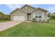 Charming single-story home featuring a brick driveway, well-manicured lawn, and an attached two-car garage at 616 Posadas Cir, Punta Gorda, FL 33983