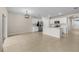 Open-concept kitchen with white cabinetry, stainless steel appliances, and neutral tile flooring at 616 Posadas Cir, Punta Gorda, FL 33983