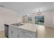 Bright kitchen with stone countertops and stainless appliances connecting to the living area at 616 Posadas Cir, Punta Gorda, FL 33983