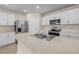Modern kitchen featuring stainless steel appliances, white cabinets, and center island at 616 Posadas Cir, Punta Gorda, FL 33983