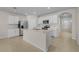 Bright kitchen featuring white cabinets, stainless steel appliances, and a central island with a sink at 616 Posadas Cir, Punta Gorda, FL 33983