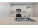 Bright kitchen with white cabinets, stainless appliances, and a view of the archway at 616 Posadas Cir, Punta Gorda, FL 33983
