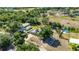 Aerial view of a charming single-Gathering home with a pool, surrounded by lush greenery and trees at 8035 Hillman Ave, Punta Gorda, FL 33982