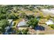 Aerial view of single-story home featuring green exterior, mature trees, and an expansive lot at 8035 Hillman Ave, Punta Gorda, FL 33982