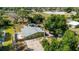 Aerial view of single-story home featuring green exterior, mature trees, and an expansive lot at 8035 Hillman Ave, Punta Gorda, FL 33982