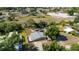 Aerial view of single-story home featuring green exterior, mature trees, and an expansive lot at 8035 Hillman Ave, Punta Gorda, FL 33982